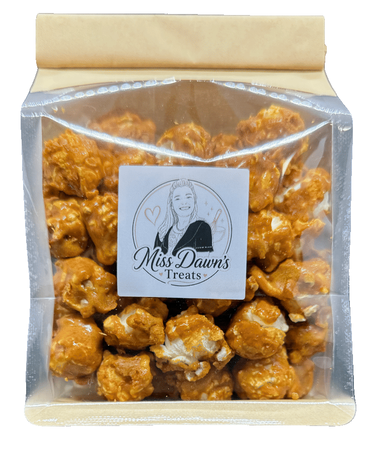 Miss Dawn's classic caramel popcorn in its handmade-labeled bag, packed full of glossy caramel-coated popcorn